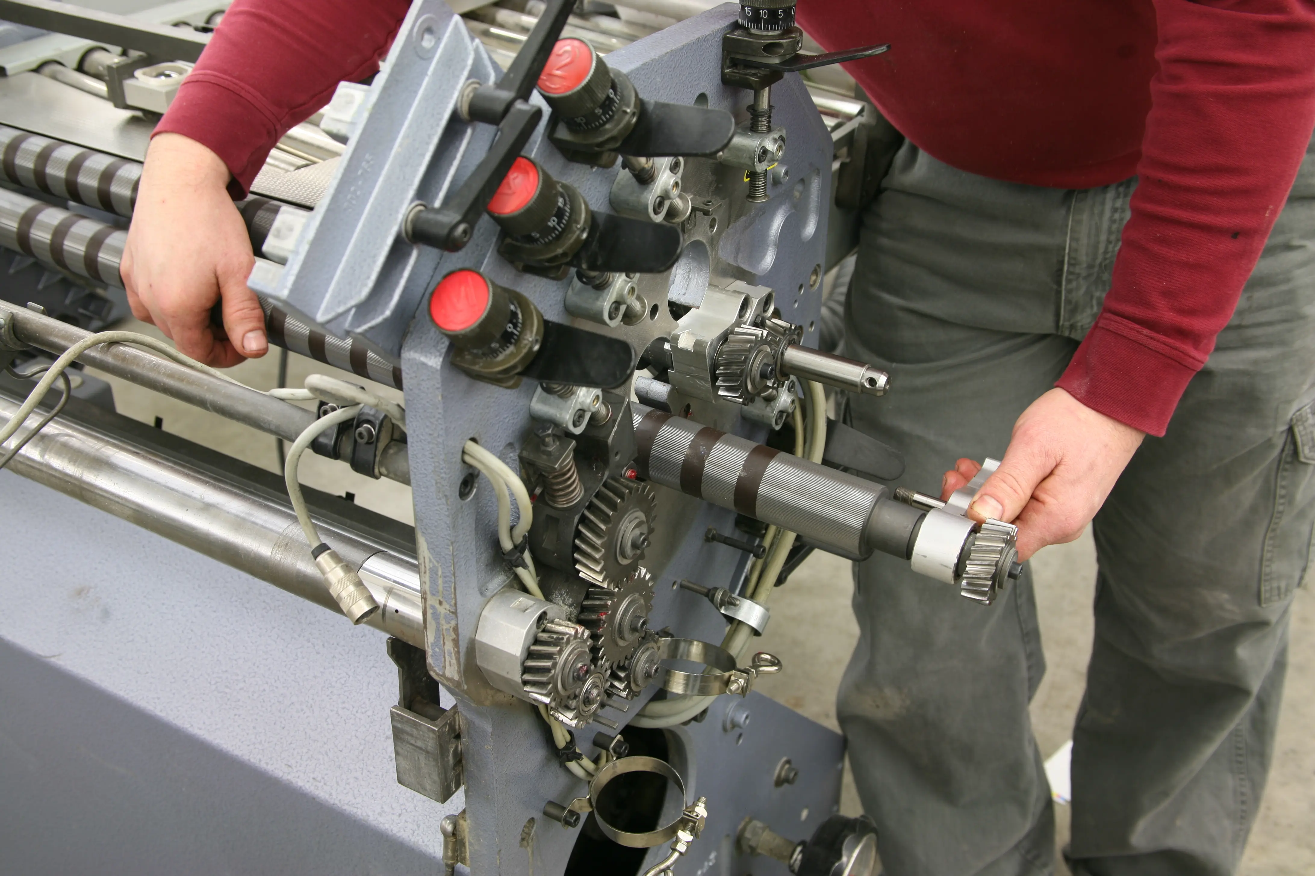 Kenny Behling working with folder machine equipment
